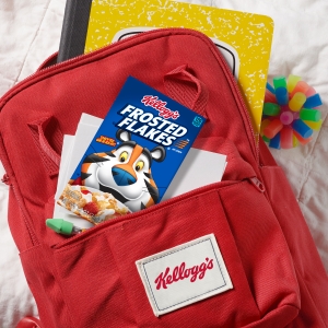 Individual serving sizes of Frosted Flakes fit into kids backpacks along with school supplies, toys